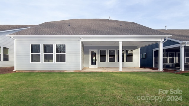 rear view of house with a patio area and a lawn