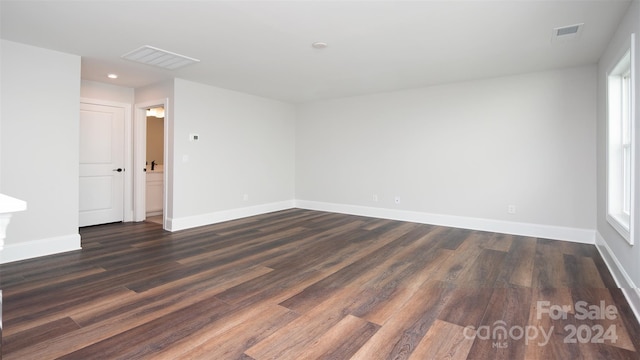 spare room featuring dark hardwood / wood-style floors