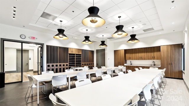 dining room with a high ceiling and sink