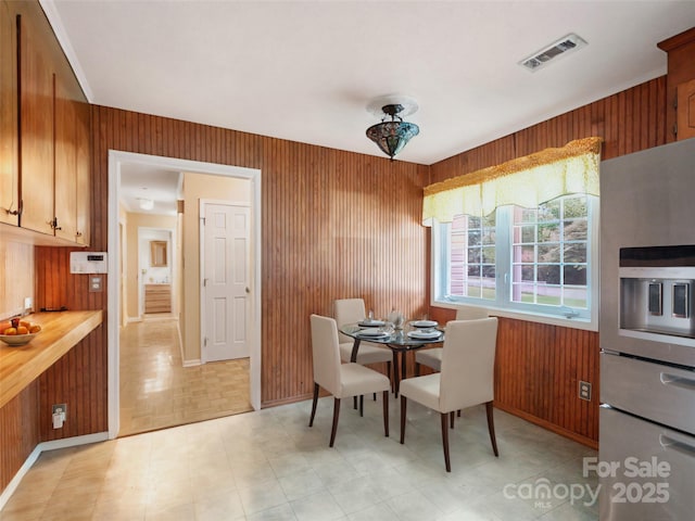 dining area featuring wood walls