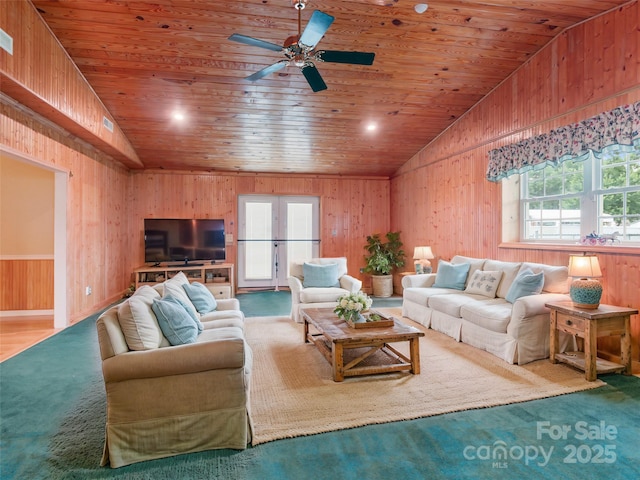 living room featuring ceiling fan, wooden walls, vaulted ceiling, and wooden ceiling