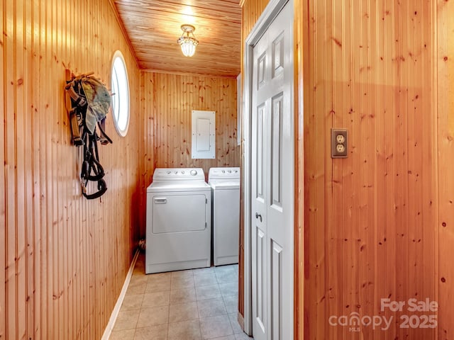 laundry area featuring light tile patterned floors, wooden walls, wooden ceiling, and independent washer and dryer