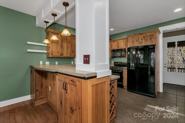 kitchen with kitchen peninsula, hanging light fixtures, dark wood-type flooring, and black appliances