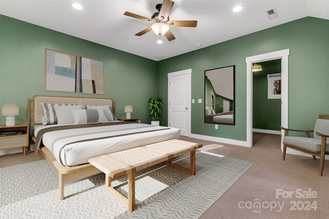 bedroom with ceiling fan, light carpet, and lofted ceiling