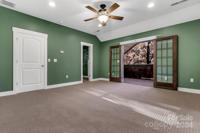 interior space featuring french doors, carpet floors, vaulted ceiling, and ceiling fan