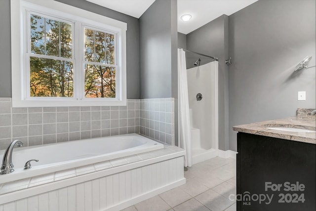 bathroom featuring vanity, separate shower and tub, and tile patterned floors