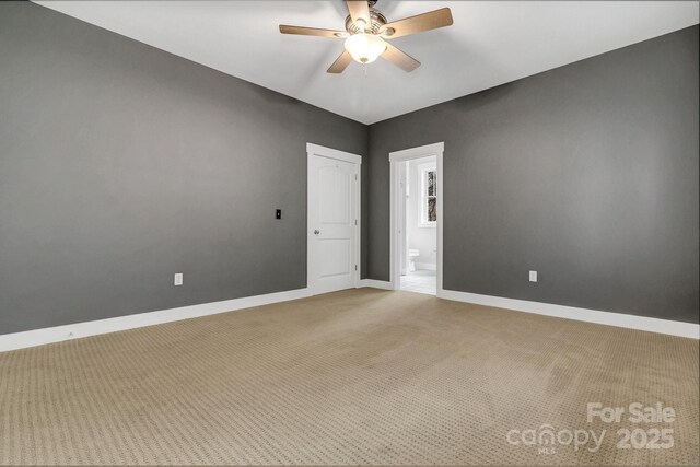 unfurnished room with light carpet, baseboards, and ceiling fan