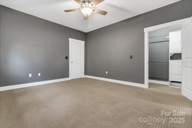 unfurnished bedroom with a ceiling fan, baseboards, a closet, and light colored carpet