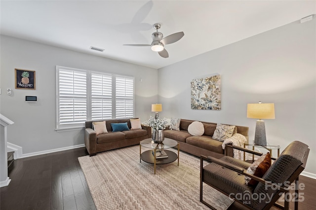 living room featuring ceiling fan and dark hardwood / wood-style flooring