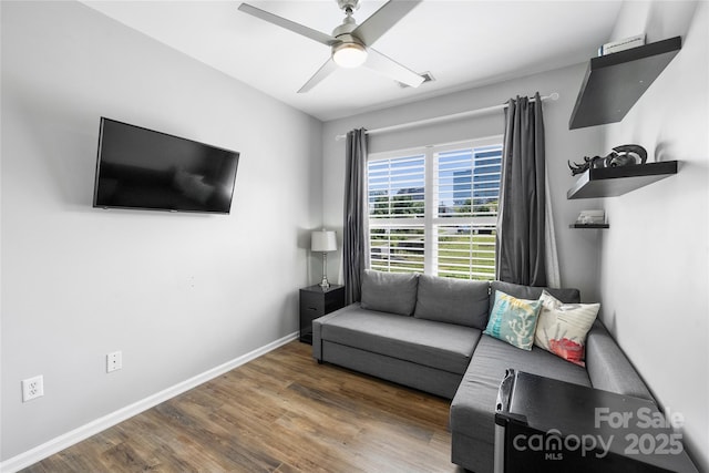 living room featuring ceiling fan and hardwood / wood-style floors