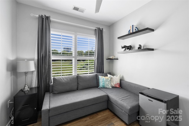 living room featuring dark hardwood / wood-style floors and ceiling fan