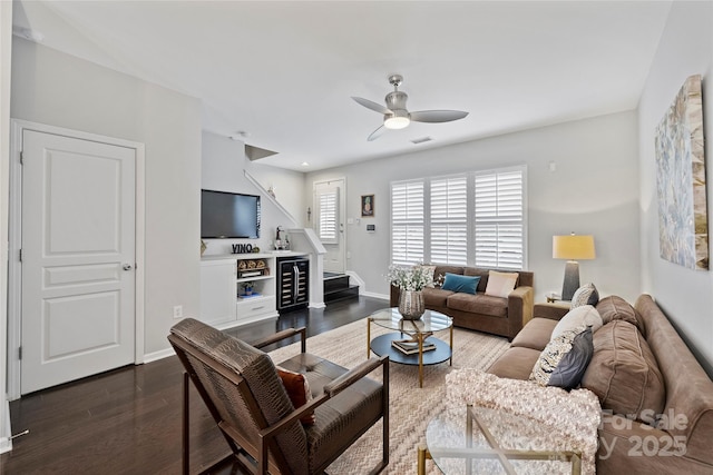 living room with ceiling fan and dark hardwood / wood-style flooring