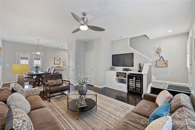 living room with dark wood-type flooring, beverage cooler, and ceiling fan