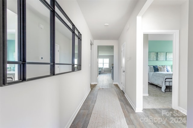 corridor featuring hardwood / wood-style floors