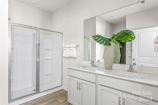 bathroom with vanity, an enclosed shower, and hardwood / wood-style floors