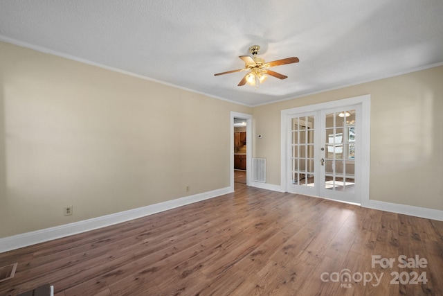 unfurnished room featuring french doors, ceiling fan, crown molding, and wood-type flooring