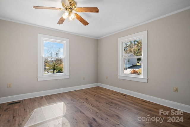 spare room featuring ceiling fan, wood-type flooring, and ornamental molding