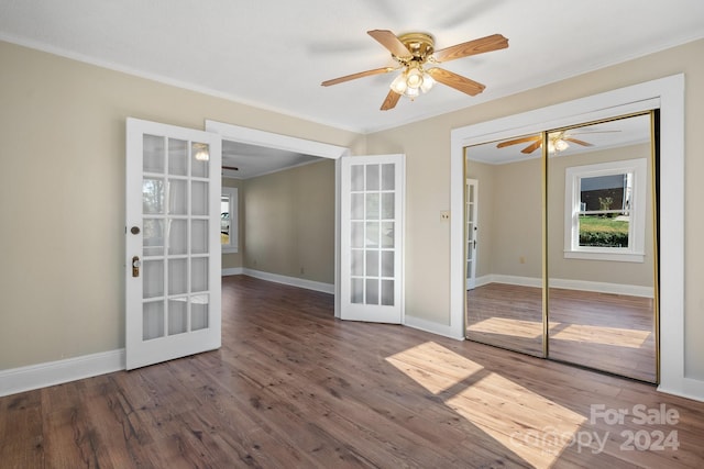 unfurnished room featuring hardwood / wood-style flooring, ceiling fan, crown molding, and french doors