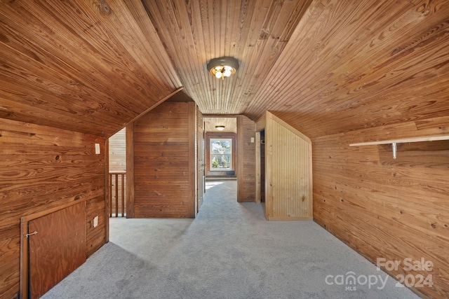 additional living space with wooden walls, carpet, wood ceiling, and vaulted ceiling