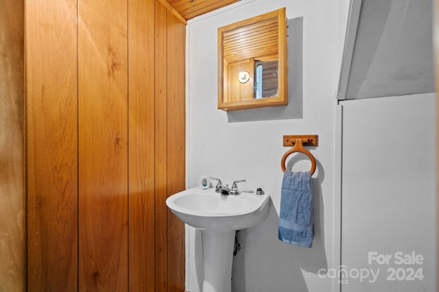 bathroom featuring sink and wood ceiling