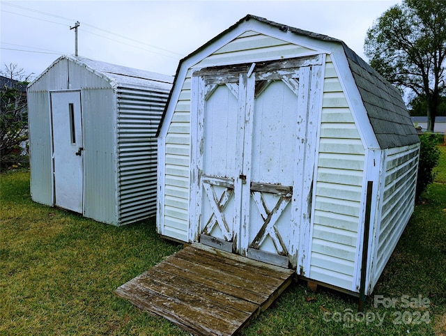 view of outbuilding featuring a yard