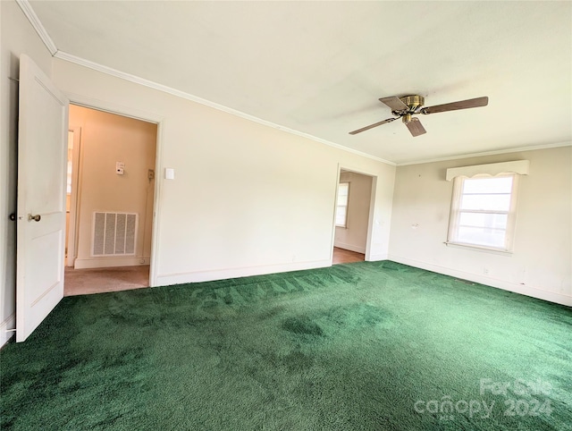 carpeted spare room featuring ceiling fan and crown molding