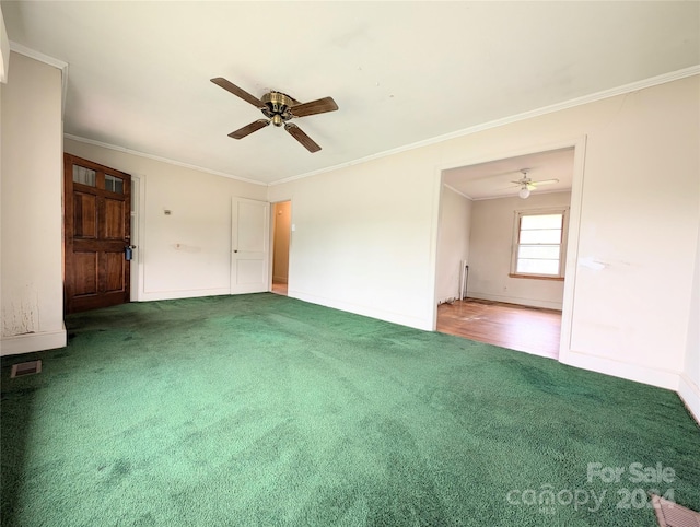 unfurnished living room with ceiling fan, crown molding, and carpet