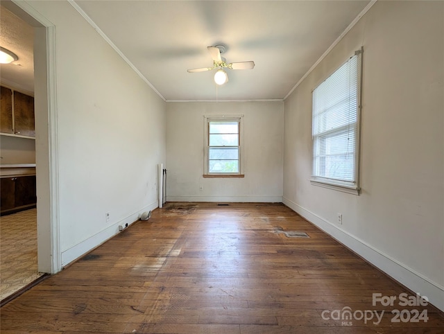 empty room featuring dark hardwood / wood-style flooring, ceiling fan, and crown molding