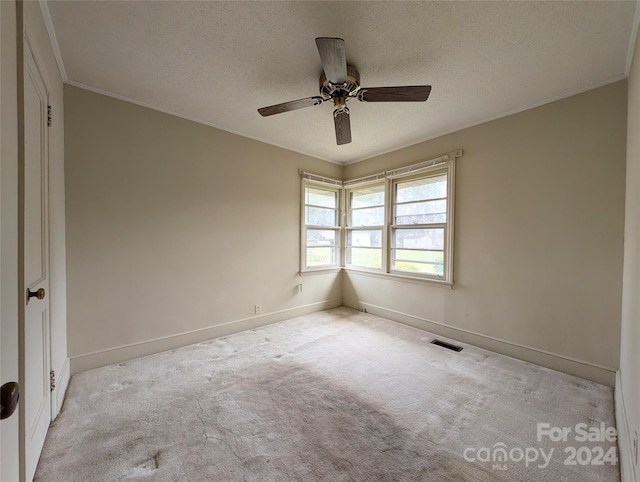 unfurnished room featuring crown molding, light carpet, a textured ceiling, and ceiling fan