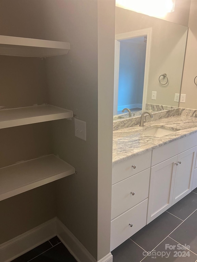 bathroom with vanity and tile patterned flooring