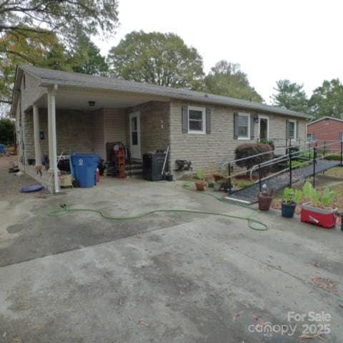 view of front of home featuring a carport and central AC