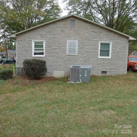 view of property exterior with cooling unit and a lawn