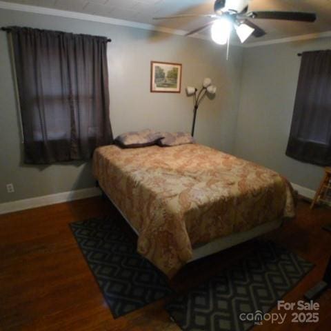 bedroom with hardwood / wood-style flooring, crown molding, and ceiling fan