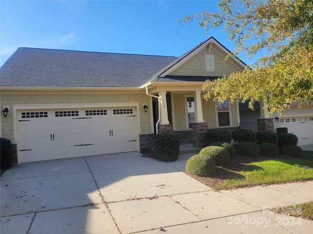 craftsman-style house featuring a garage and a porch