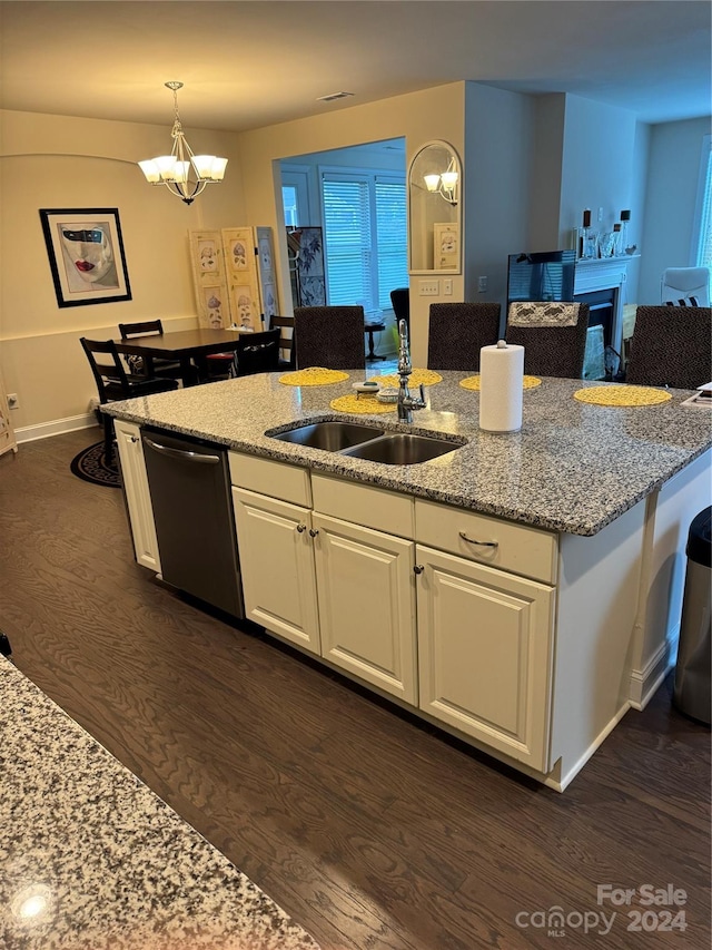 kitchen featuring white cabinetry, dark hardwood / wood-style flooring, stainless steel dishwasher, and light stone countertops