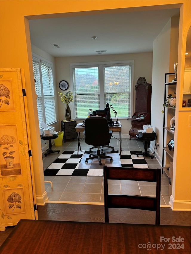 tiled office space with a healthy amount of sunlight