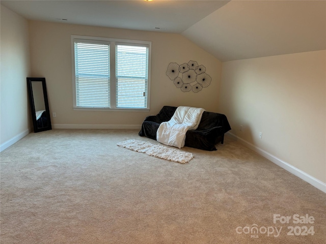 unfurnished room with light carpet and lofted ceiling