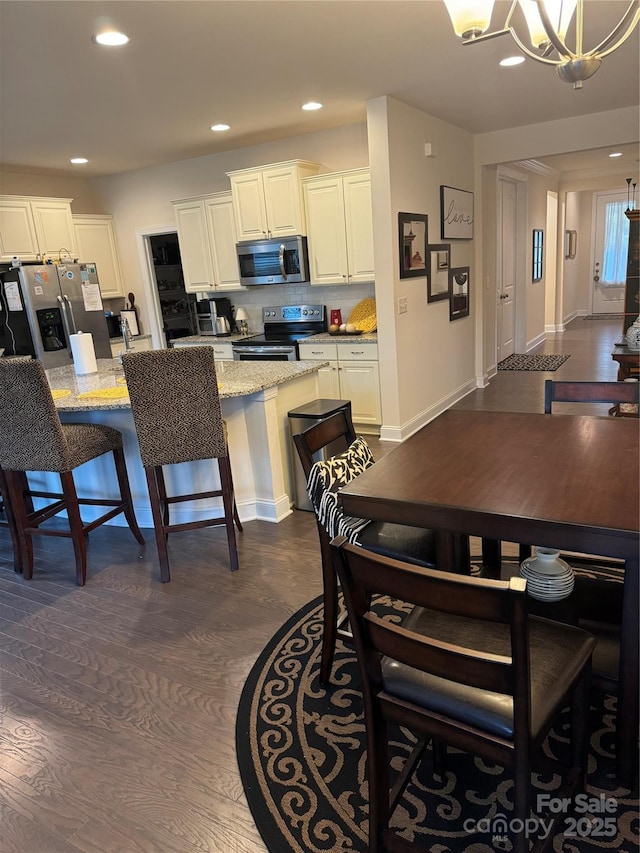 dining space with a chandelier and recessed lighting