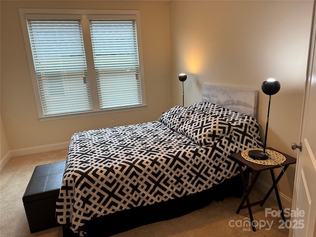 bedroom with carpet and baseboards