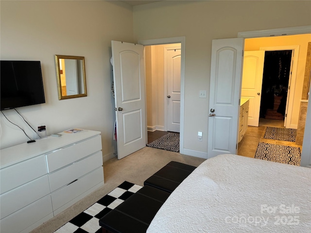 bedroom featuring baseboards and light carpet