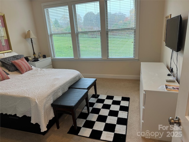 carpeted bedroom featuring baseboards