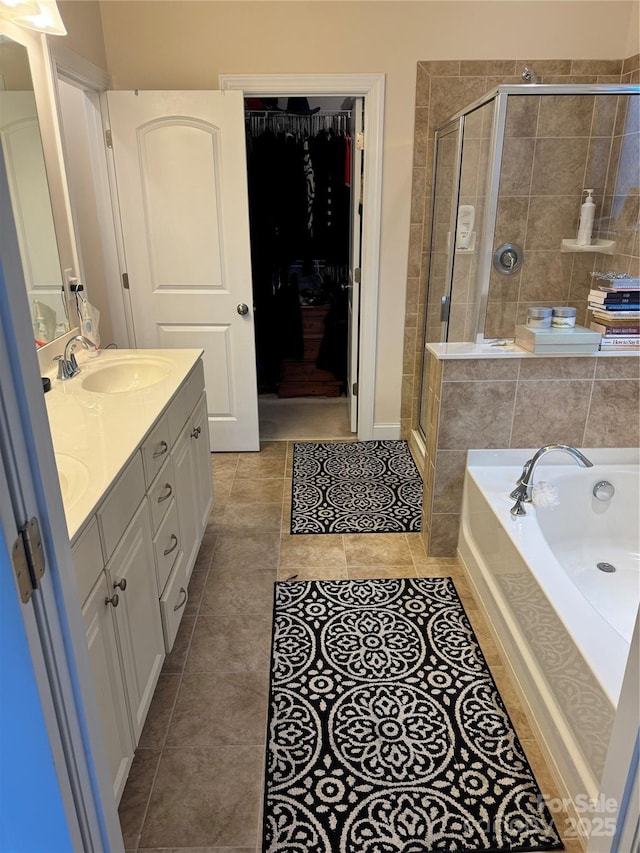 full bathroom with a stall shower, tile patterned flooring, a garden tub, and double vanity