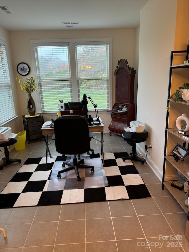 tiled office space with healthy amount of natural light and baseboards
