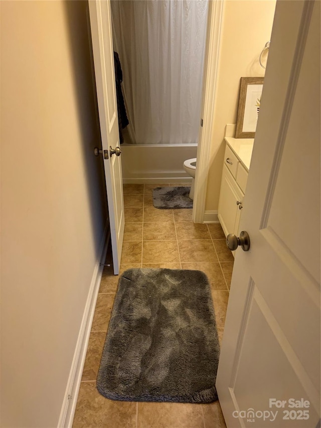 full bath with vanity, tile patterned floors, toilet, shower / bathtub combination with curtain, and baseboards