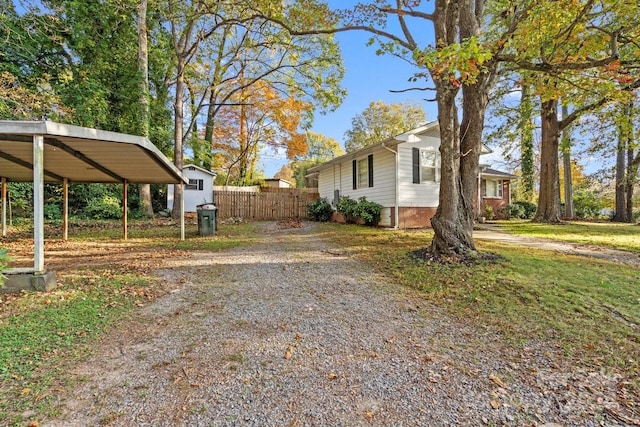 view of property exterior featuring a lawn and a carport