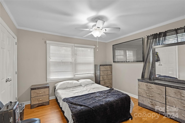 bedroom featuring hardwood / wood-style flooring, ceiling fan, and ornamental molding