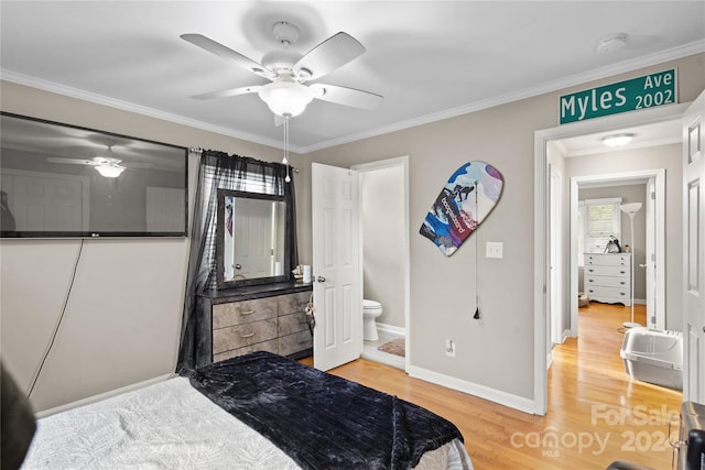 bedroom featuring ensuite bathroom, wood-type flooring, ceiling fan, and crown molding