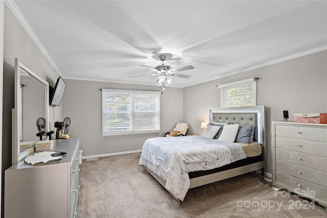 carpeted bedroom with multiple windows, ceiling fan, and crown molding