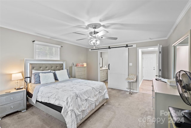 bedroom featuring light colored carpet, a barn door, ensuite bathroom, ceiling fan, and crown molding