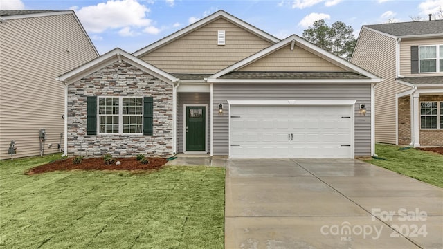 view of front of property with a front yard and a garage